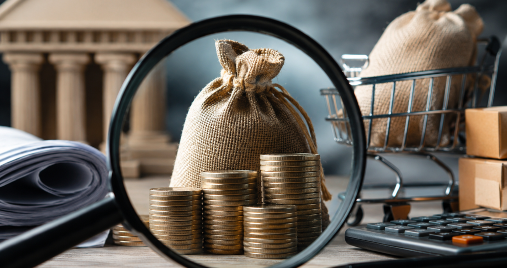 Illustration representing the investigation into fake GST Input Tax Credit fraud in India with financial documents, coins, and a magnifying glass.