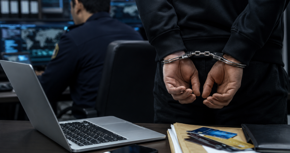 Cybercrime investigators examining digital evidence during an investigation into a fake IPO investment fraud that resulted in the arrest of a suspect.